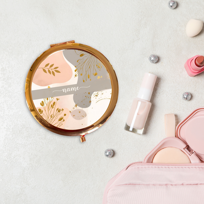 Makeup items including a compact mirror, nail polish, and a pink case on a light background