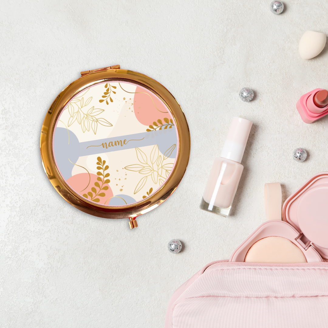 Round decorative mirror with floral design on a light background with makeup items.